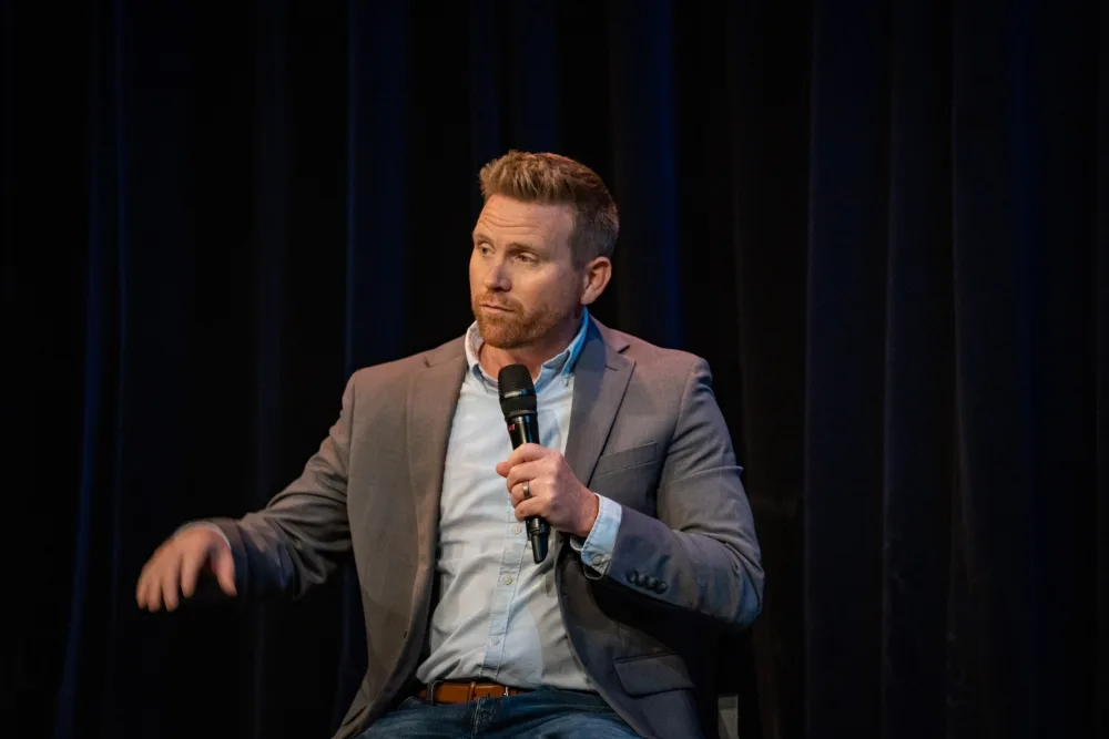 Kyle Renke speaking on stage